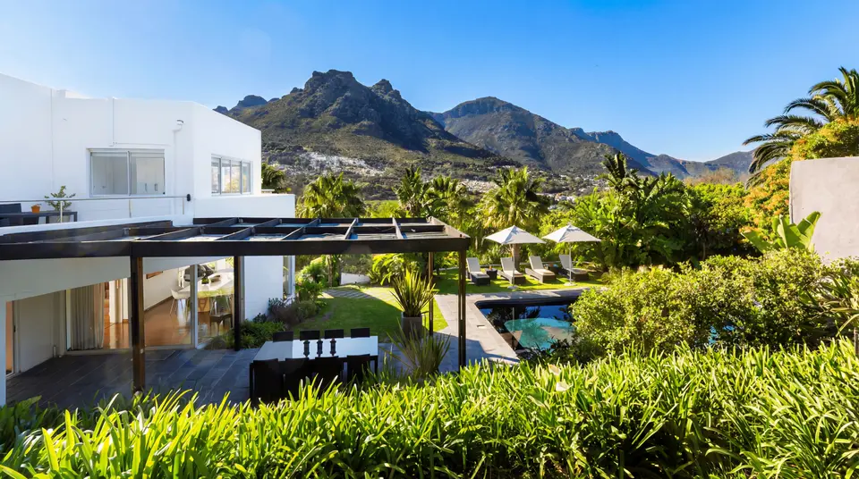The modern pool terrace of the Hout Bay Guest House with spectacular views of the mountains and the ocean in Cape Town